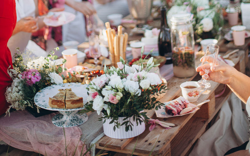 a-bouquet-of-flowers-on-a-table-from-pallets_-celebrating-with-friends-and-family-in-a-park-or-garden_-outdoor-picnic_-festive-boho-wedding-table