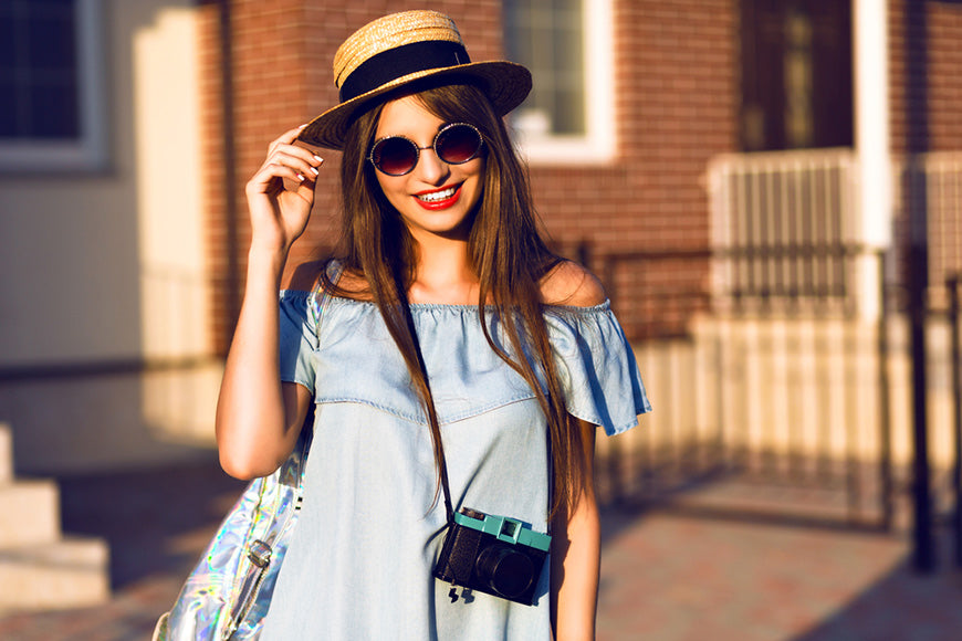 Young pretty hipster cheerful girl with a panama hat