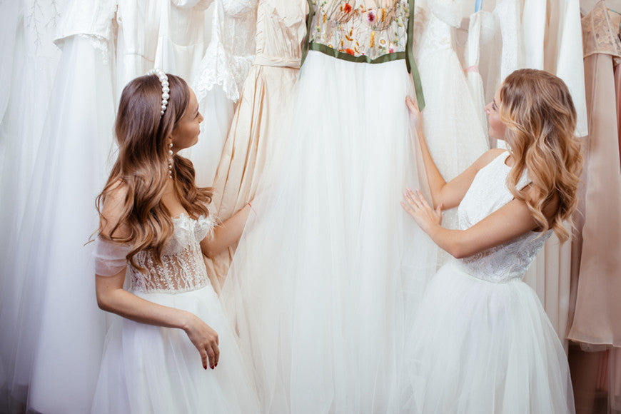 two-girls-are-choosing-white-dresses