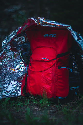 A backpack protected from the rain with a space blanket - The Atomic Bear