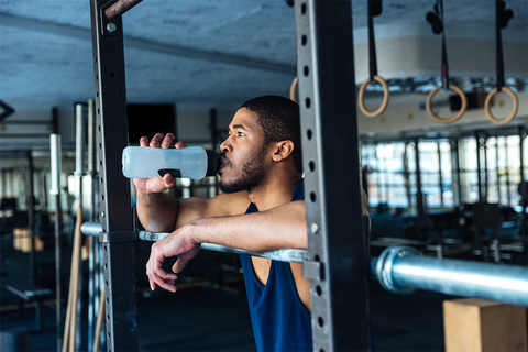 Man Drinking Water in the Gym