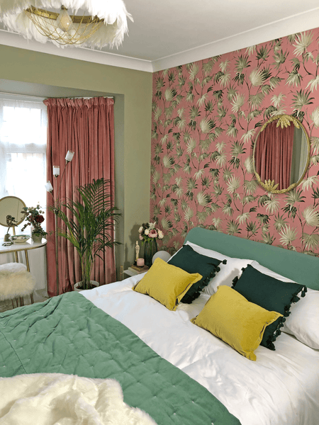 Bold pink and green floral wallpaper in an art deco inspired bedroom scheme.