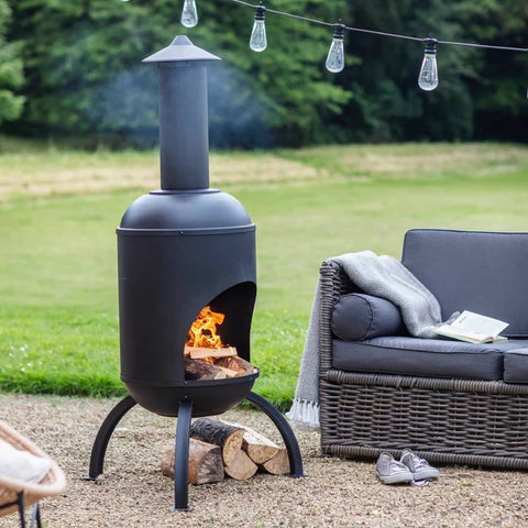 Outdoor chiminea with lit fire