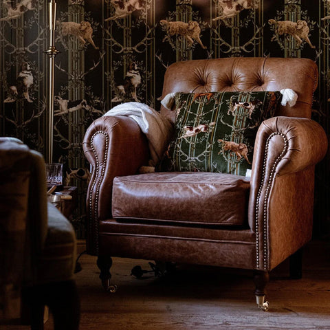 Brown leather tufted armchair