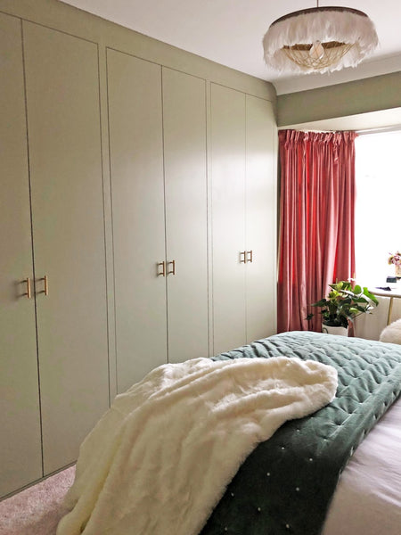 Bespoke wardrobes painted in the same colour as the walls and woodwork.