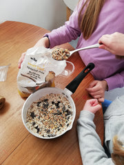 Adding seeds to the suet in the pan