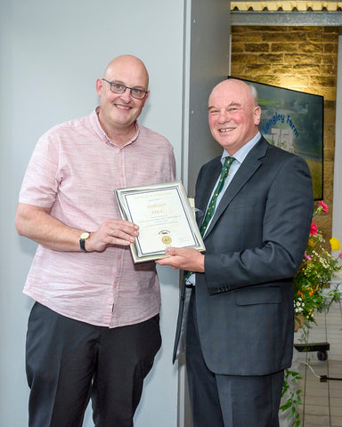 Adrian Hill receives long service award from Jimmy Dickinson