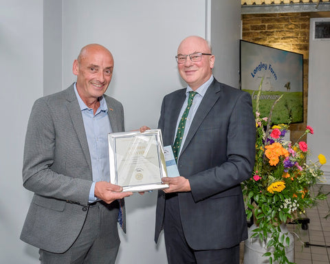 Andrew Clayton receives long service award from Jimmy Dickinson