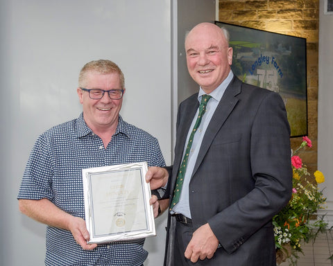 Chris McNulty receives long service award from Jimmy Dickinson