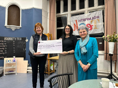 Dawn Whiteley MBE receives cheque from Emma Woods-Bolger of One Community and Greta Bradley of the BGCT