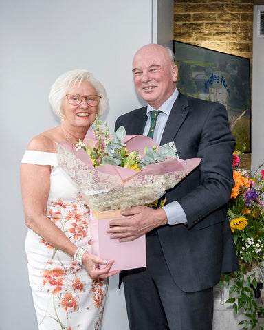 Dianne Heppenstall receives flowers in recognition of her retirement and long service at Longley Farm from Jimmy Dickinson