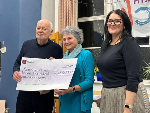 Stephen Sheard of EcoHolmes receives cheque from Greta Bradley of the BGCT and Emma Woods-Bolger of One Community