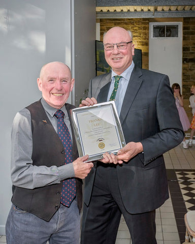 Frankie Lee receives long service award from Jimmy Dickinson