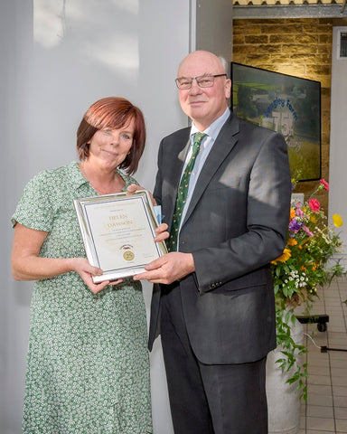 Helen Dawson receives long service award from Jimmy Dickinson