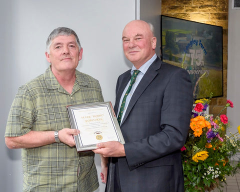 Mark Robinson receives long service award from Jimmy Dickinson