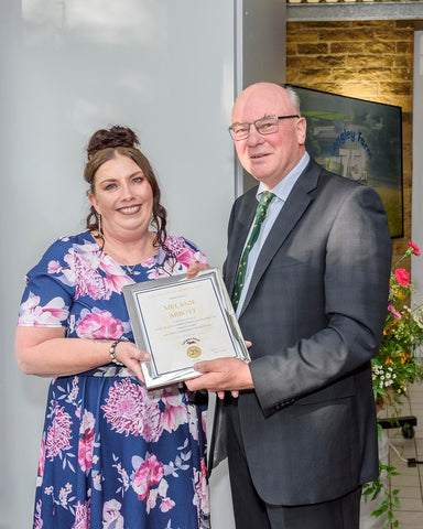 Melanie Abbott receives long service award from Jimmy Dickinson