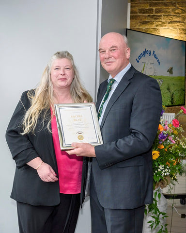 Rachel Bray receives long service award from Jimmy Dickinson