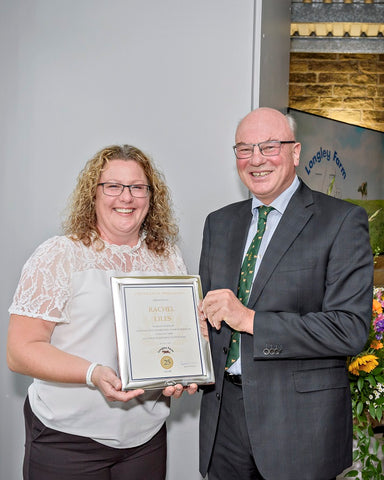 Rachel Liles receives long service award from Jimmy Dickinson