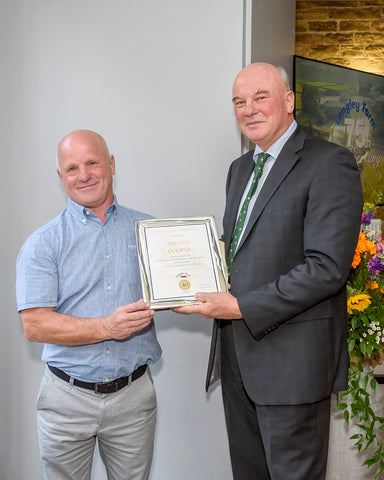 Stevie Cooper receives long service award from Jimmy Dickinson