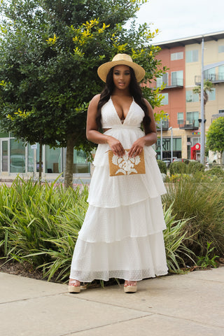 woman in white dress holding purse