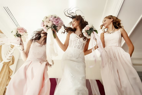 3 ladies in wedding dress holding bouquet