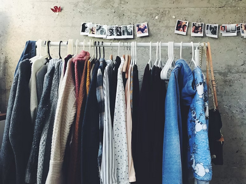 a collection on clothes hanging as a wardrobe