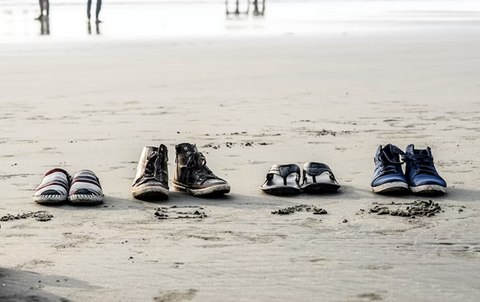 couple of shoes placed on the beach