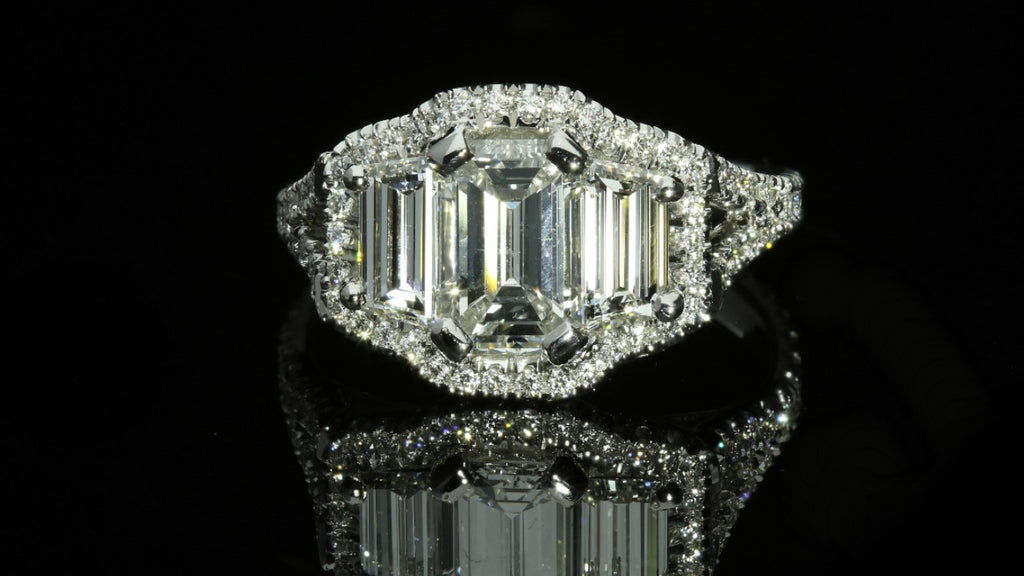 Three stone emerald cut halo engagement ring