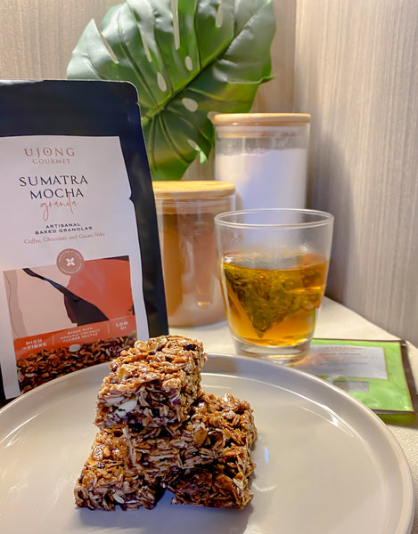 Granola Bars made using Ujong granolas and paired with a cup of Gryphon tea with two jars in the background