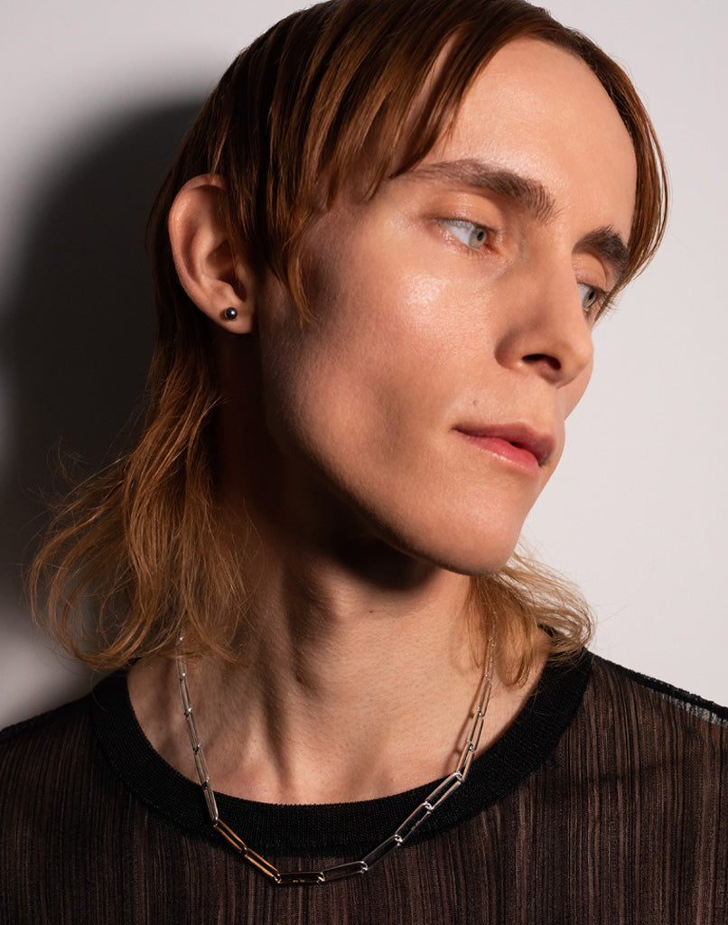 Simon Nygard wearing Kinraden Exhaling Her recycled sterling silver and 18k gold necklace