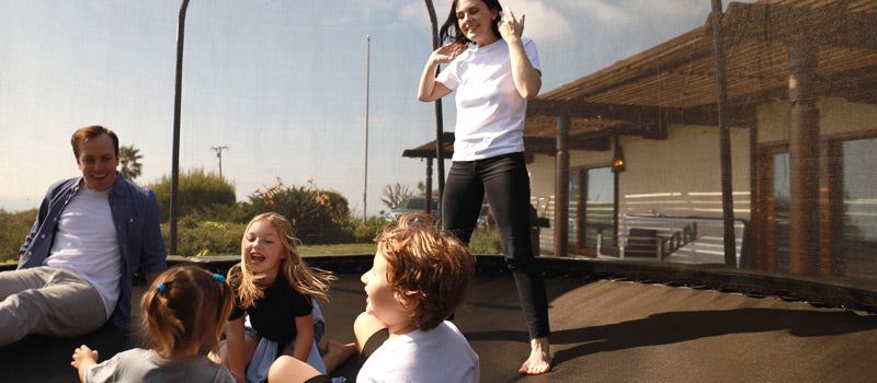 Family on a backyard trampoline