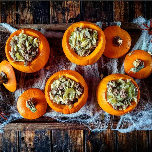 Image of green chili stew inside small pumpkins for Halloween