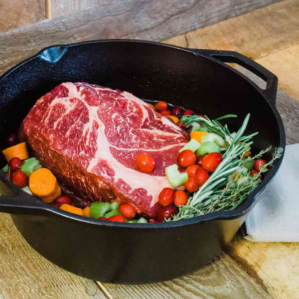 A Felton Angus Beef chuck roast with cranberries in a dutch oven.