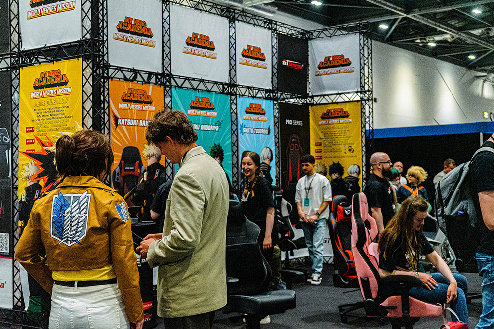 A group of visitors at the GT Omega exhibition stand at MCM London Comic Con 2023