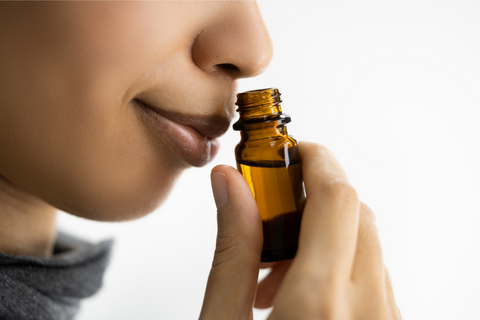 woman sniffing essential oils