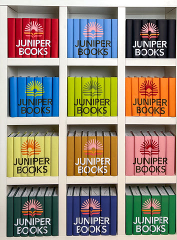 Juniper Books' New Logo on 12 book sets on a bookshelf. 
