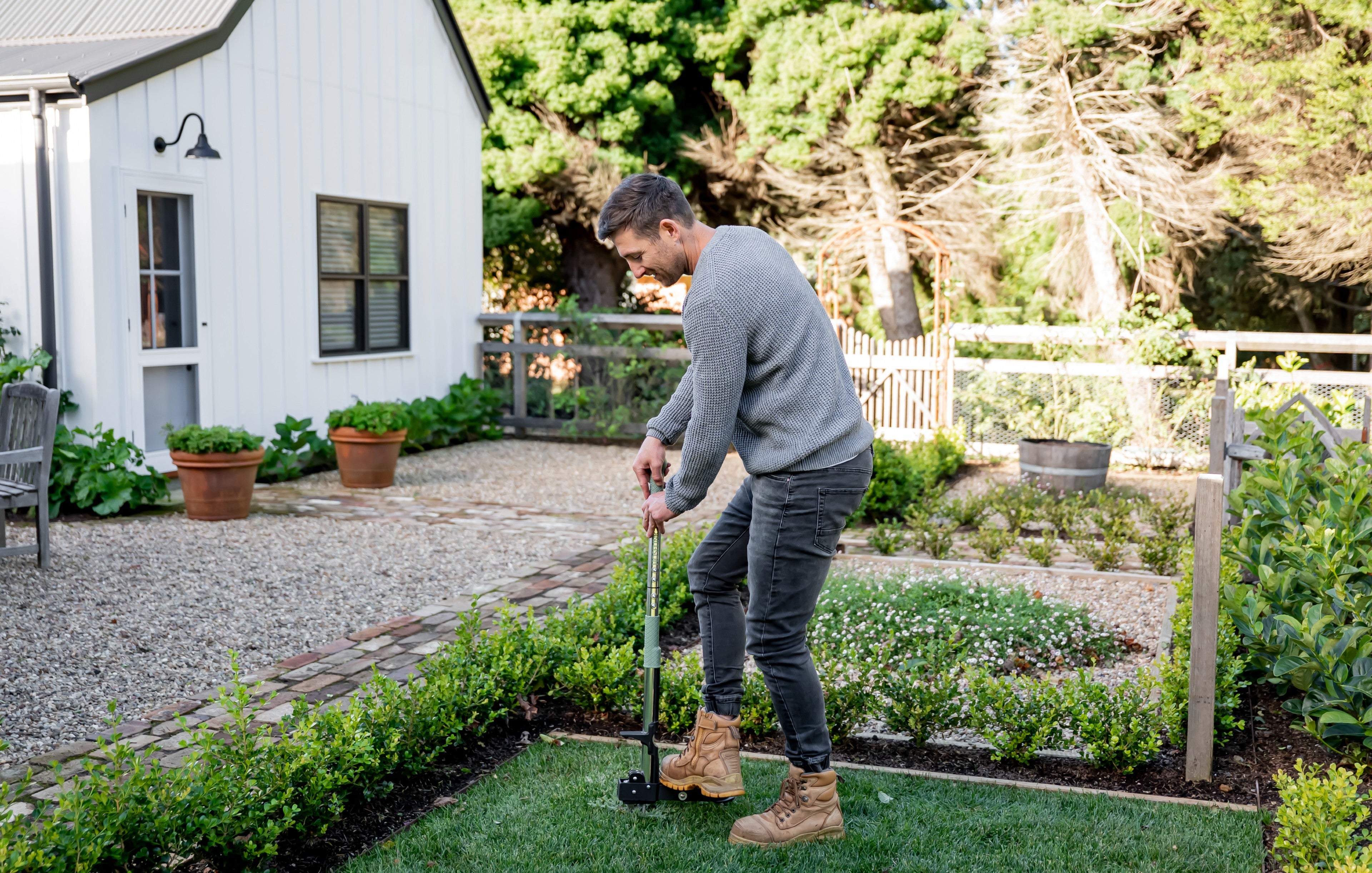 man-using-stnd-up-weed-puller-to-remove-weeds-from-lawn