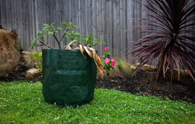 heavy-duty-planter-bag-filled-with-garden-waste-sitting-on-grass