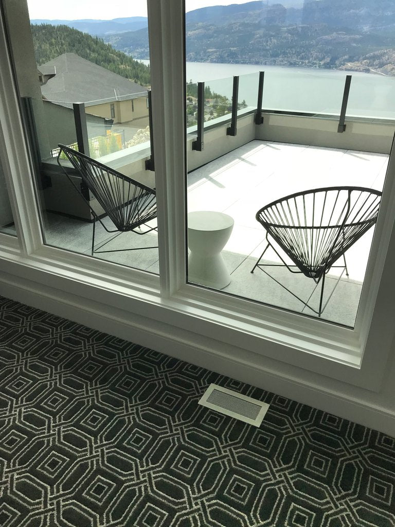 air vent covers brushed chrome finish on black and white design carpet white walls and window casings wilden builders kelowna showhomes by kulgrilles