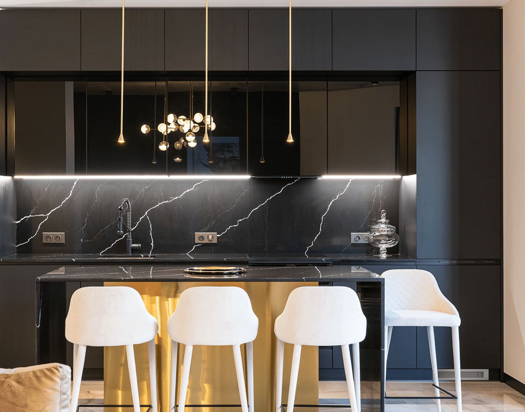 black contemporary kitchen with eat in island and black marble backsplash