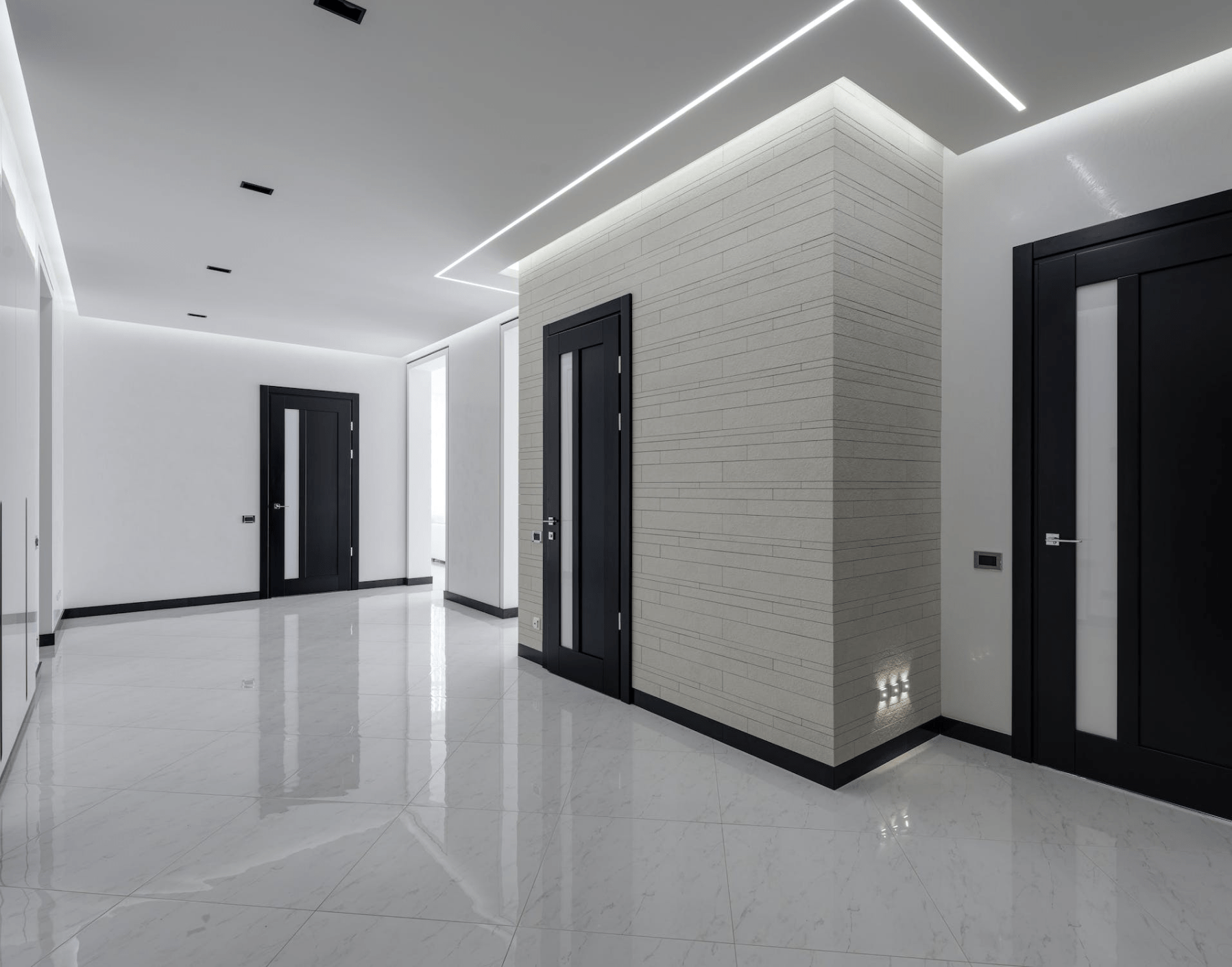 Contemporary hallway with shiny granite flooring and black doors