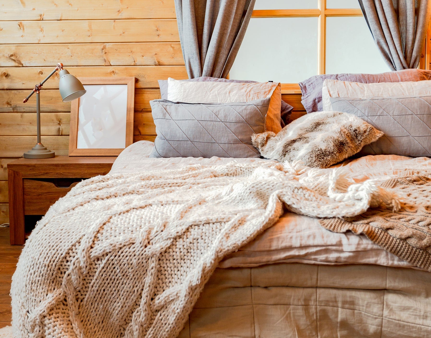 cozy wooden interior country house with layered textiles cable knit blanket min