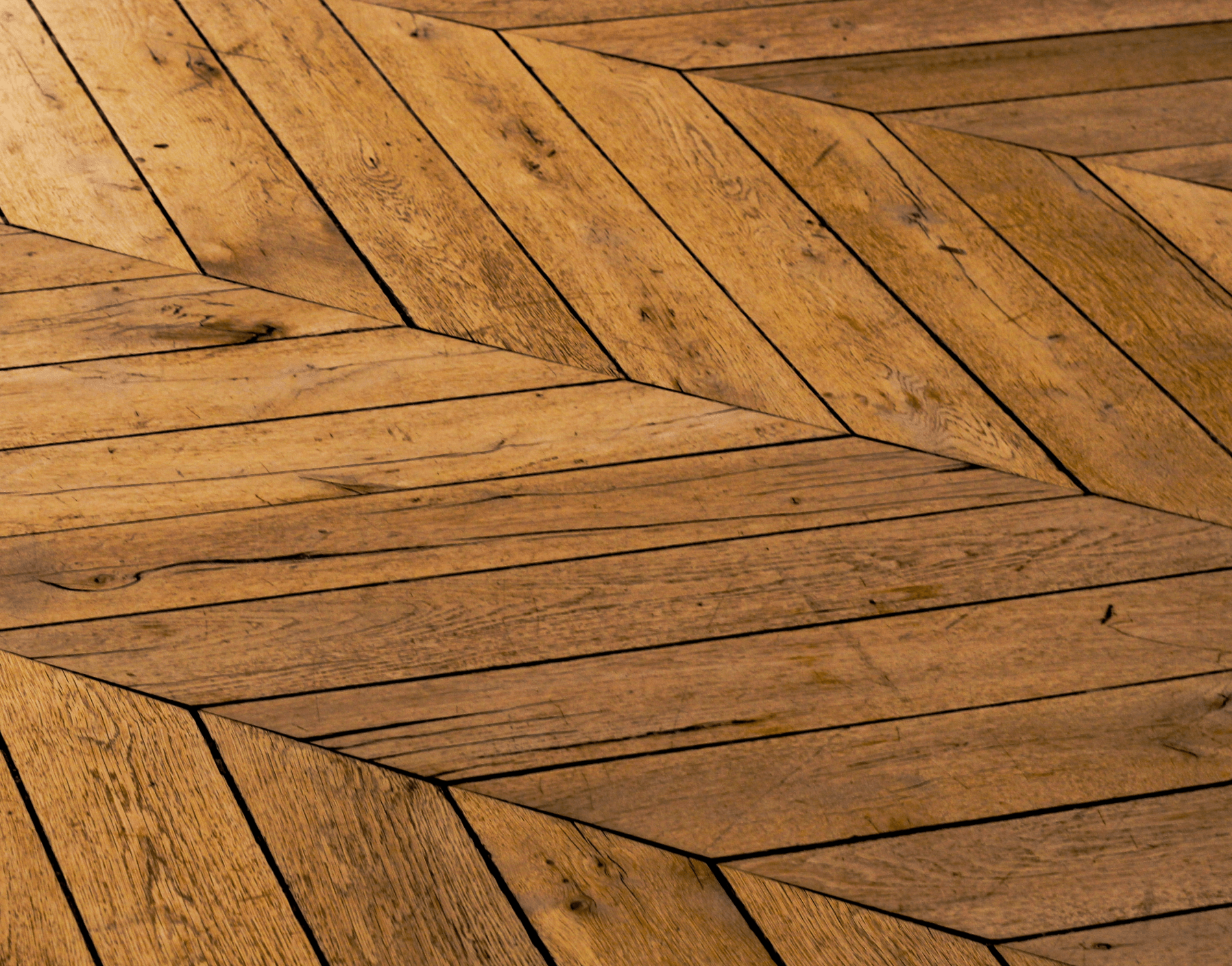 Herringbone hardwood floor in warm tones