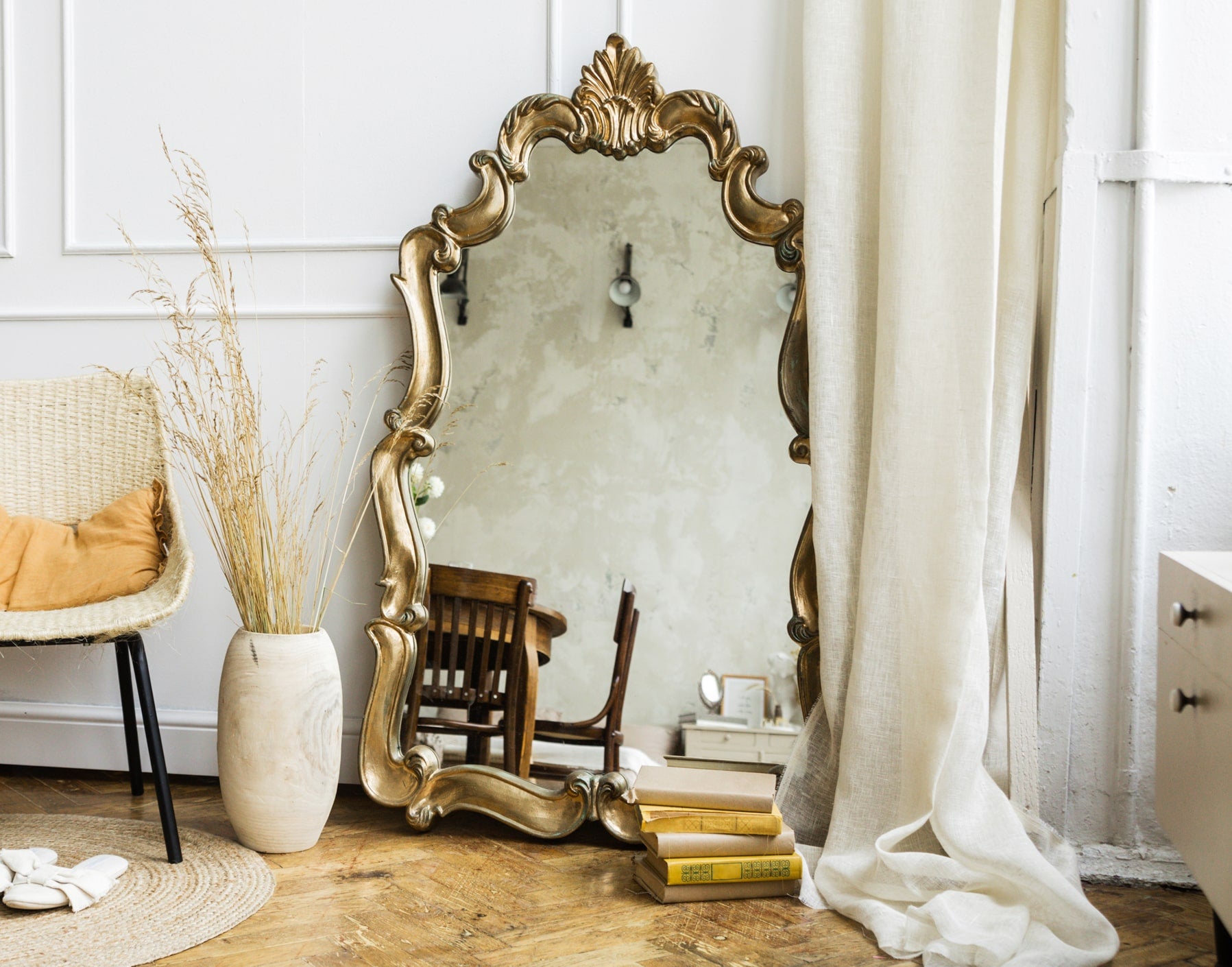 ornate oversized mirror with modern decor in bright natural light