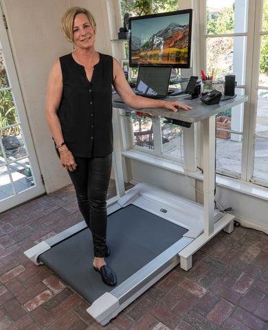 Diann Wingert standing on her Unsit Treadmill Desk shot from back right