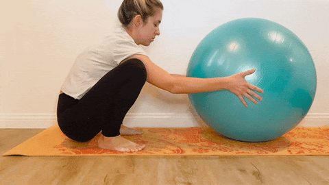 Dr. Katie Hunter demonstrating a deep squat with an inflatable ball