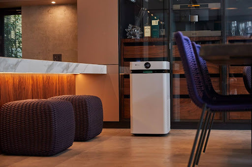 Airdog Air Purifier in a modern living room, next to the kitchen counter