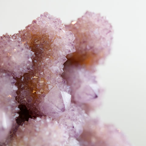 Purple amethyst spirit quartz sparkling in the sun with a subtle orange tint from iron inclusions