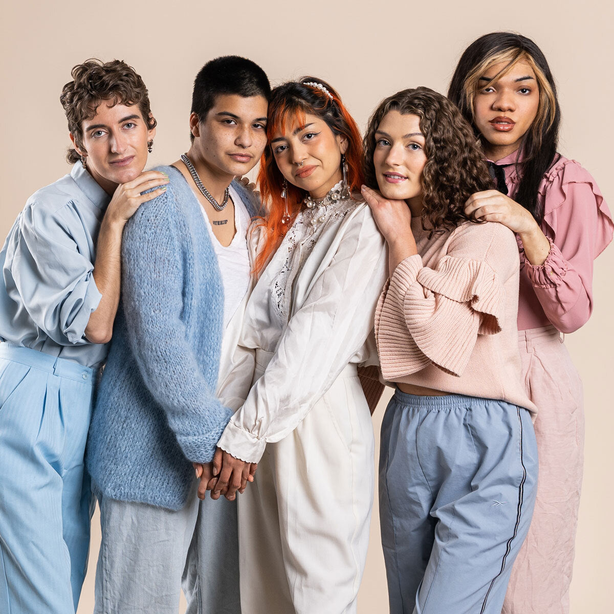 group of lgbt people leaning on eachother in pastel colors