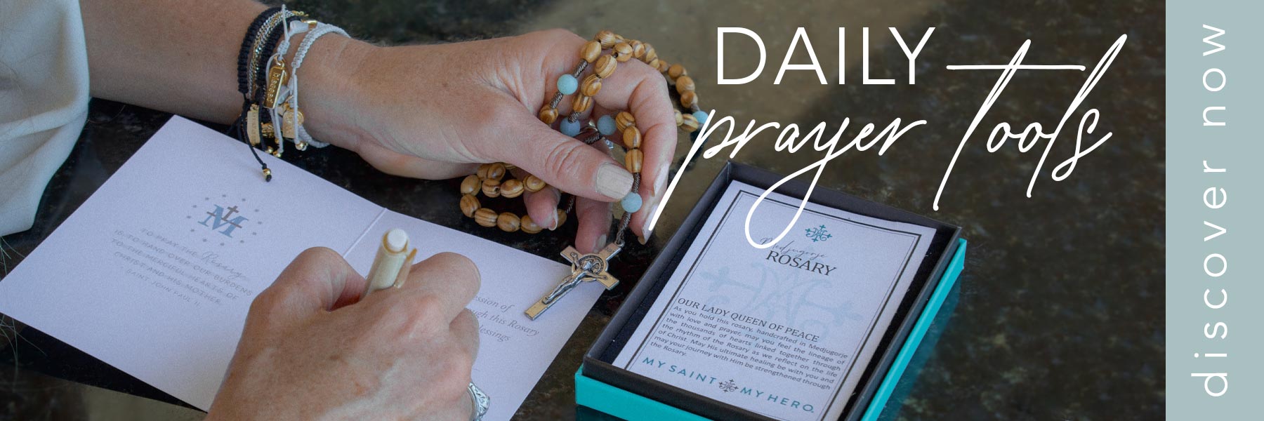 woman writing on Rosary card holding a Medjugorje Amazonite Rosary